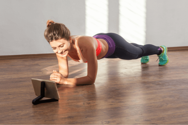 Image of woman planking in front of ipad