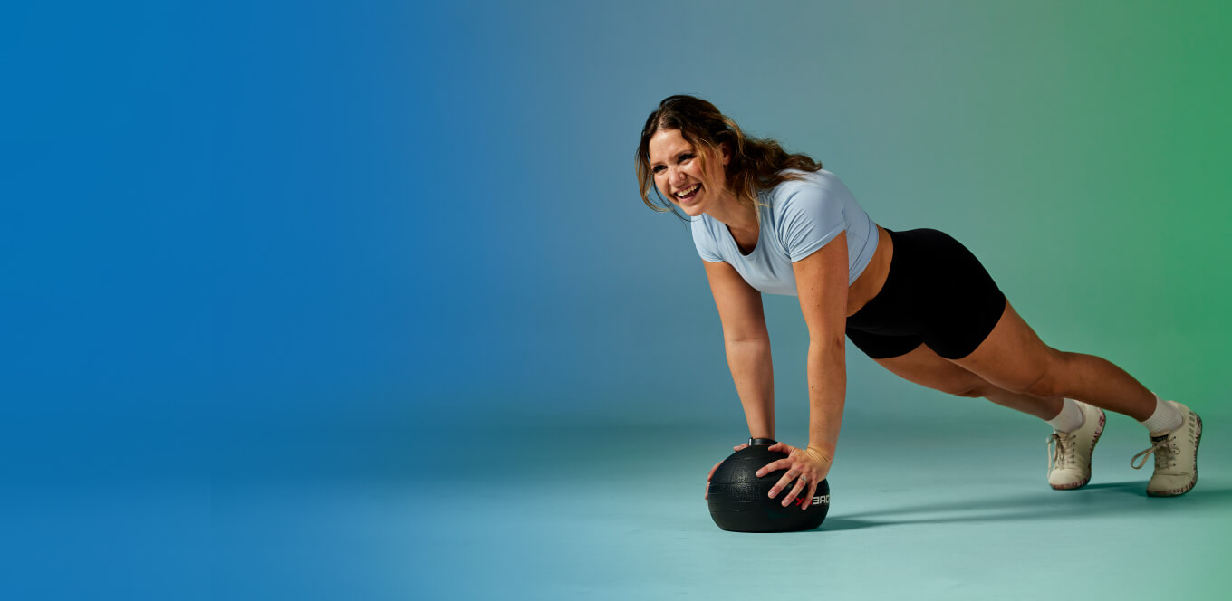 girl planking on a medicine ball