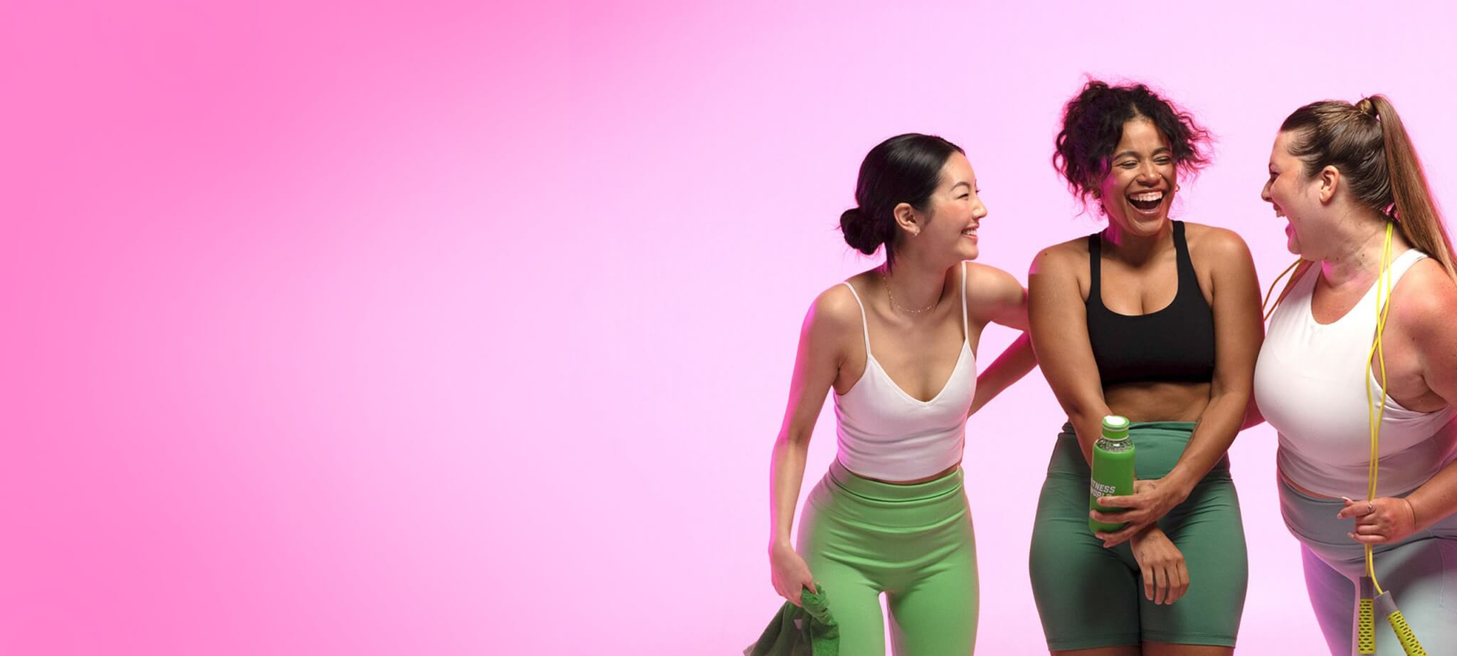 three girls in athletic wear laughing