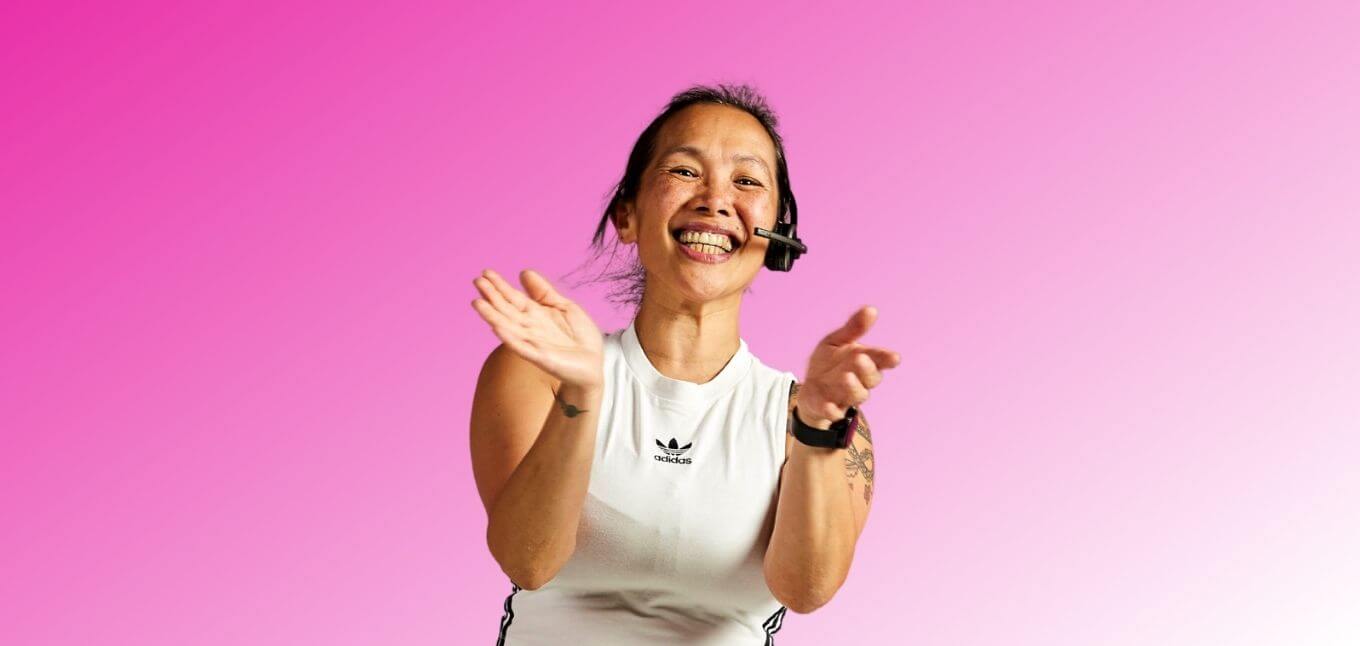 smiling fitness class instructor clapping